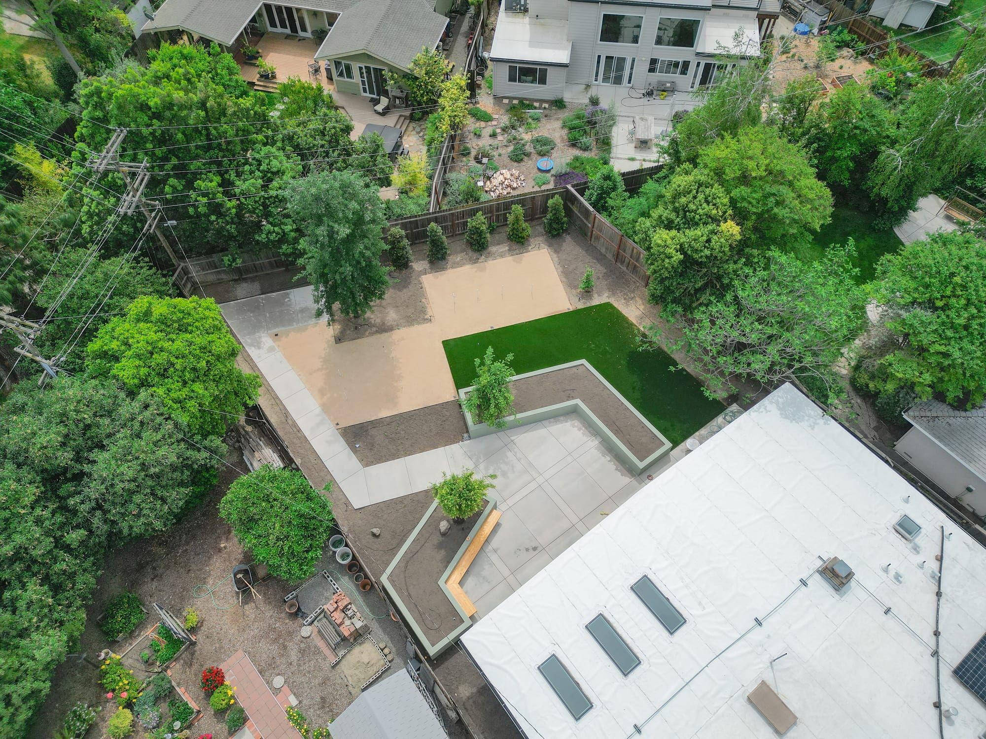 Aerial view of Sacramento backyard hardscape with artificial turf and concrete patio