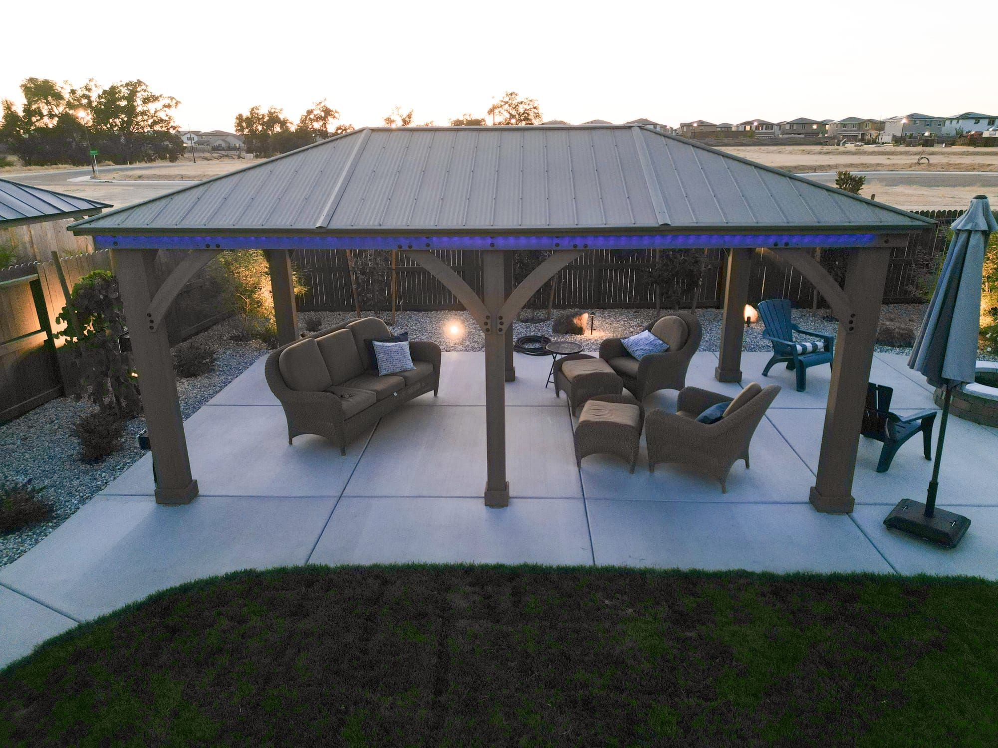 Covered patio with outdoor seating and LED lighting at dusk in Sacramento