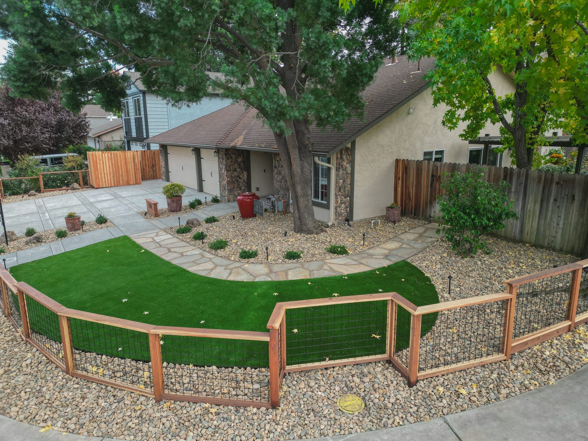 Front yard with artificial turf, flagstone walkway, and wire fencing in Sacramento