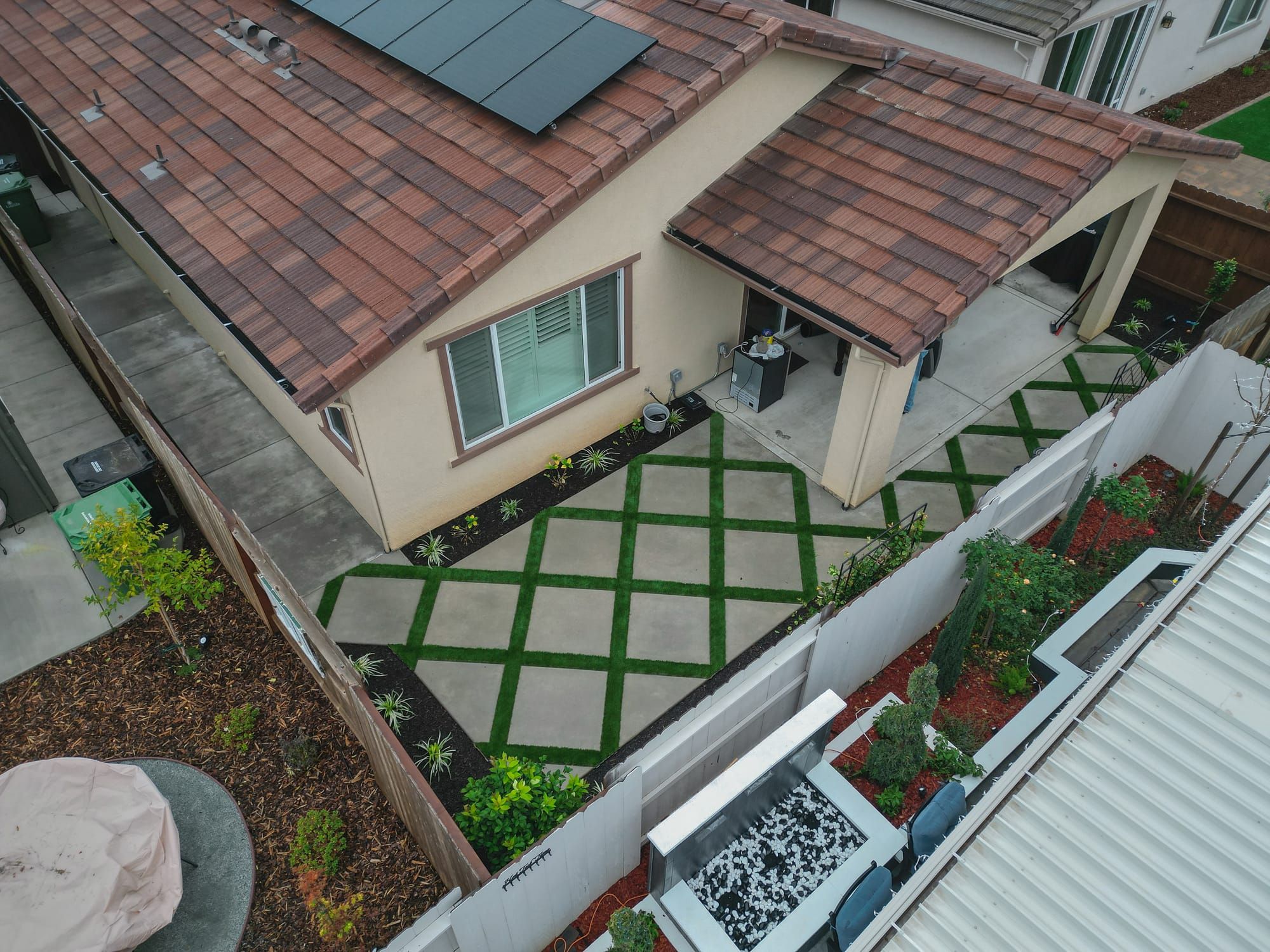 Aerial view of diamond paver and turf pattern patio in Sacramento backyard