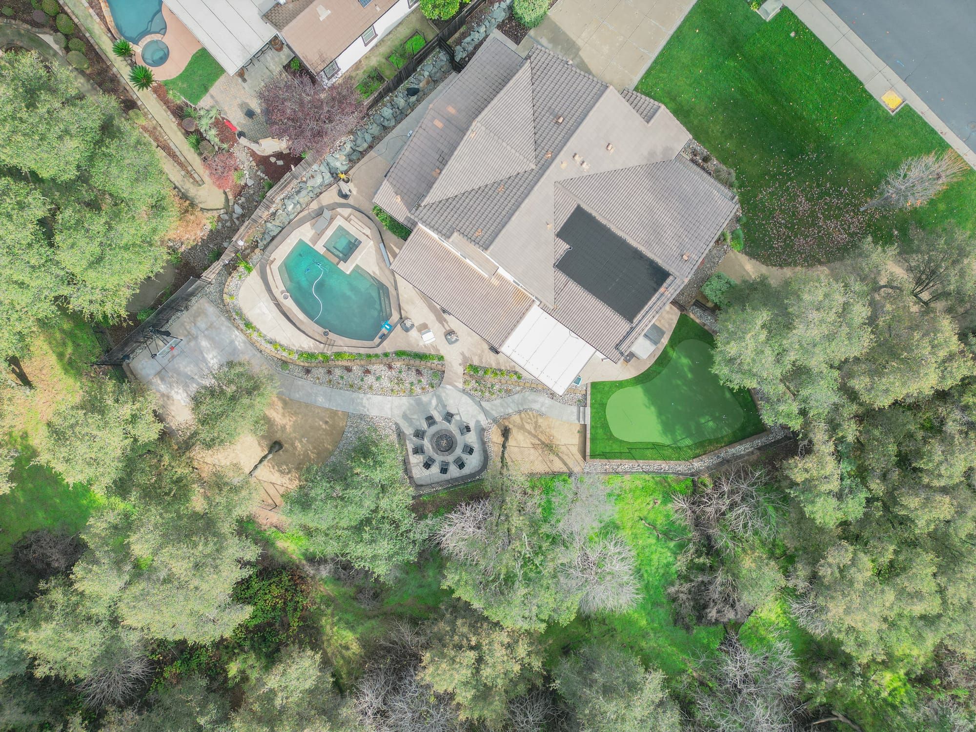 Aerial view of complete backyard landscape construction in Sacramento — pool, patio, turf, and hardscape by Stuteville Landscaping